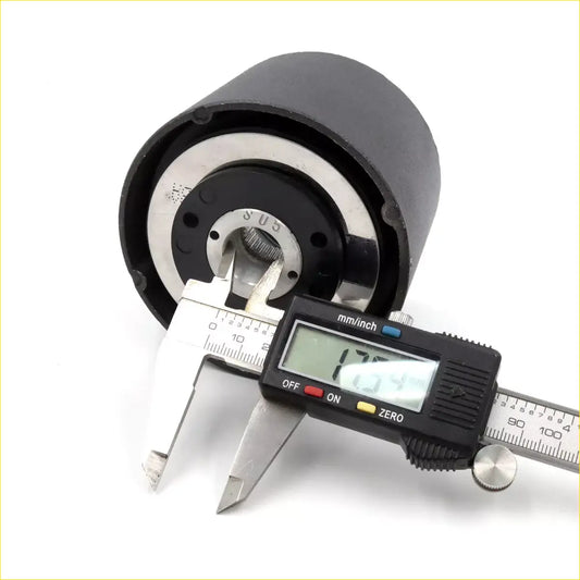 Black cylindrical boss kit steering wheel hub adapter with silver metal parts measured by digital caliper for toyota hilux