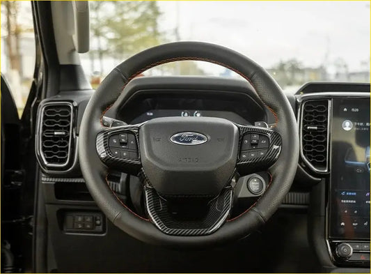 Black leather-wrapped ford ranger steering wheel with carbon fiber trim cover and red stitching for 2022+ models