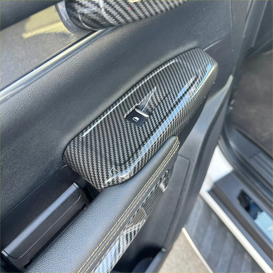 Carbon fiber interior window lift switch button panel trim cover with glossy finish and black accent stitching