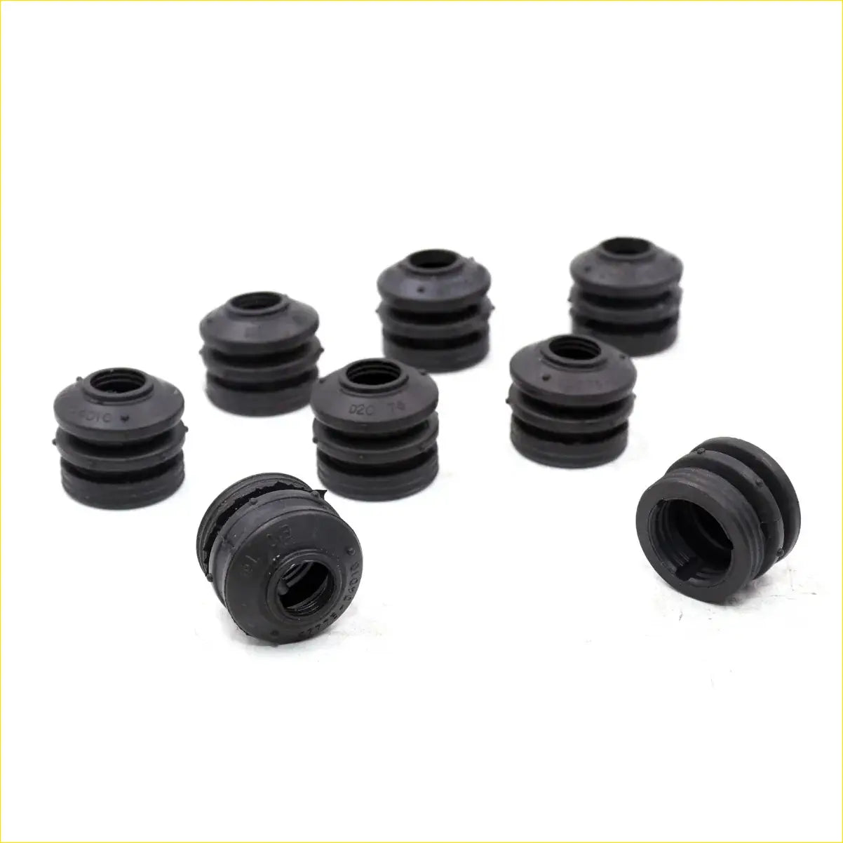 Black rubber cylindrical bushings with concentric ridges from disc brake seal kit for toyota hilux xtra cab 2005-2015