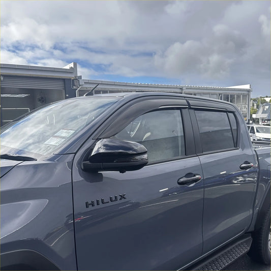 Black plastic door visors window monsoons weather shields installed on dark gray toyota hilux 2015-current