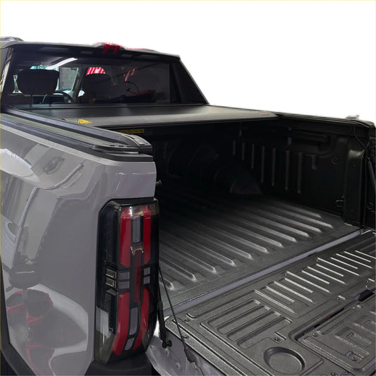 Black electric roller shutter tonneau cover over the back of ldv terron 9 truck bed for secure storage