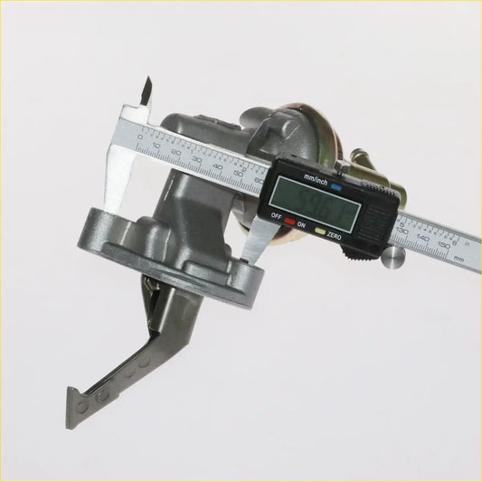Gray metallic fuel pump component being measured with digital caliper for mitsubishi galant sigma 1983-1989