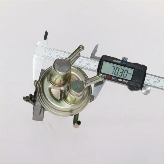 Silver metallic fuel pump for mitsubishi triton l200 1986-1996 with two cylindrical ports and circular base shown from back side