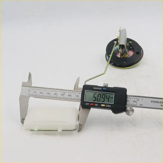 A black digital caliper with silver metallic jaws measuring millimeters shown with a fuel sender gauge for toyota hilux 1979-1983