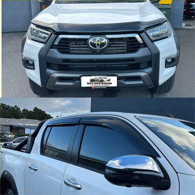Black plastic window visors installed on a white toyota hilux pickup with monsoon and bonnet guard 2021-2025