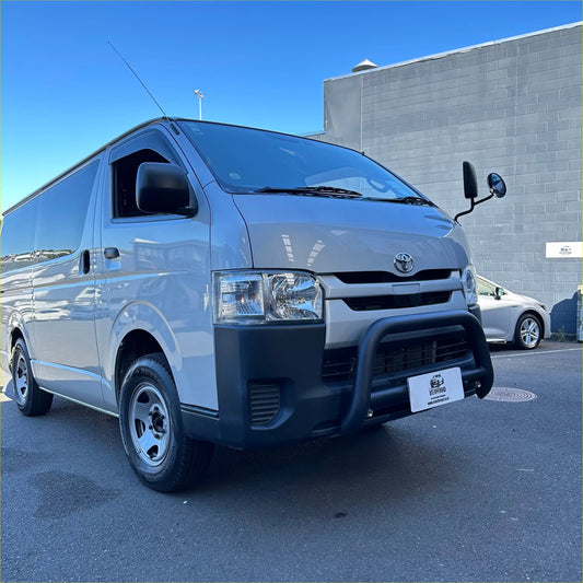Silver toyota hiace van with matte black nudge bar and black front bumper guard with chrome accents