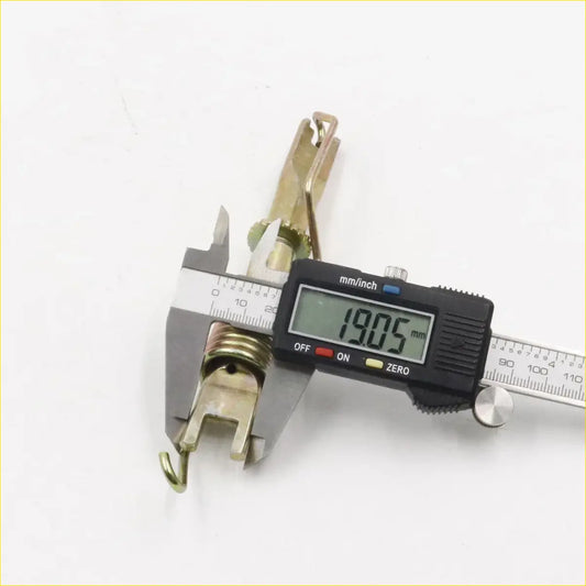 Gold-colored metal wire clamp with spring and hook for rear drum brake shoes adjuster measured at 19.05 mm