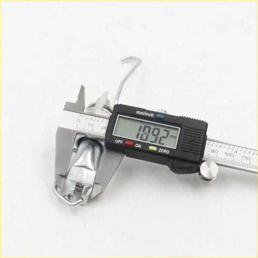 A shiny chrome metal hook of a rear drum brake shoes adjuster for toyota hilux 2wd 2005-2015 being measured