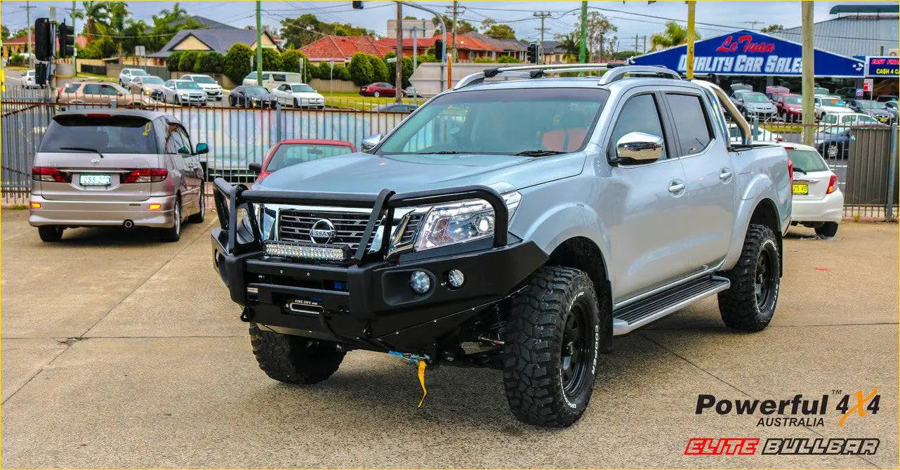Silver nissan navara pickup with black rockarmor elite steel bullbar and rugged off-road tires in front view