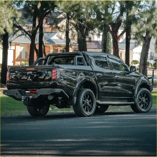 Black mitsubishi triton mq 2015-2018 shown from back with rugged matte finish and rockarmor elite steel rear step tow bar