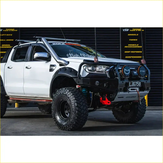 Black and silver steel rockarmor gt hoop bullbar on ford ranger wildtrak px 2 px 3 with rugged tires and roof rack