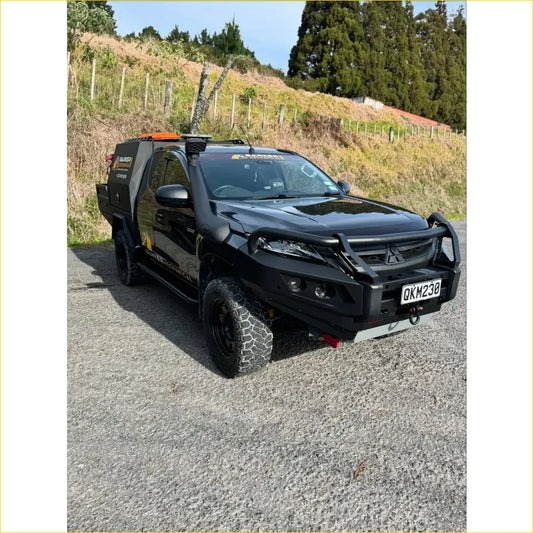 Black mitsubishi triton pickup with rockarmor gt hoop steel bullbar and rugged off-road tires for full bar replacement