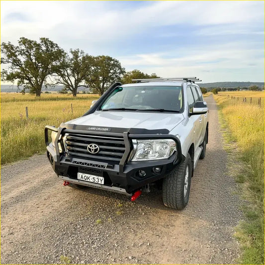 Silver toyota land cruiser with black steel rockarmor gt hoop bullbar full bar replacement and roof rack