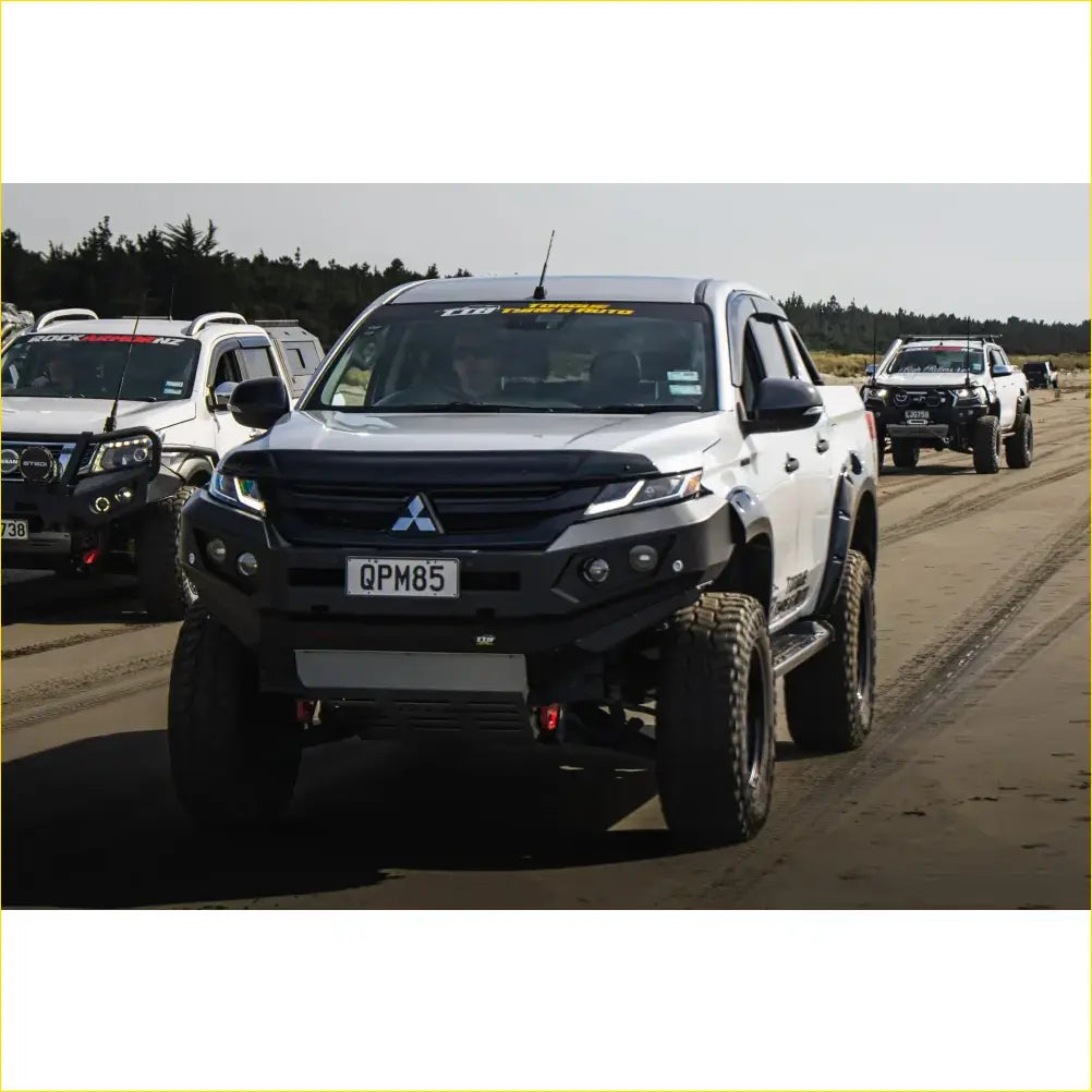 Silver Mitsubishi Triton with black steel rockarmor GT hoopless bullbar combo pack and off-road tires front view