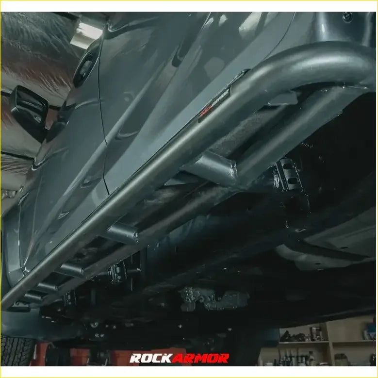 Black metal rockarmor underbody protection kit for toyota prado fj150 2009-2013 shown from back side