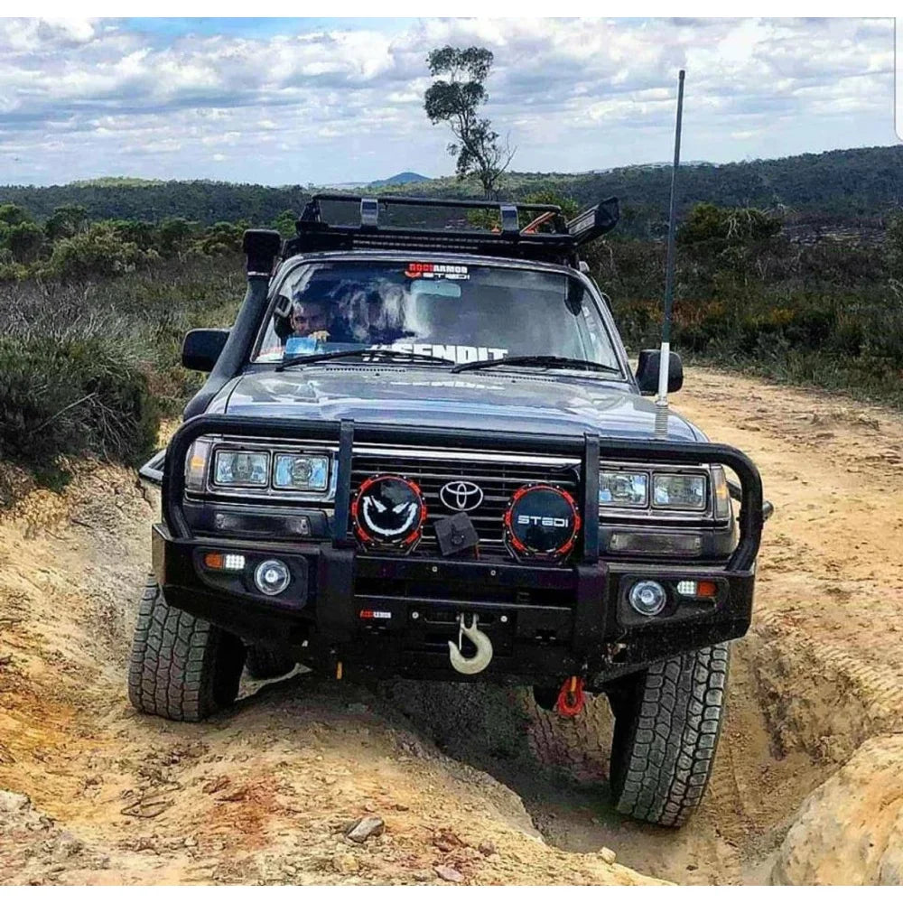 Black off-road Toyota Land Cruiser with steel bullbar and fog lights for enhanced protection