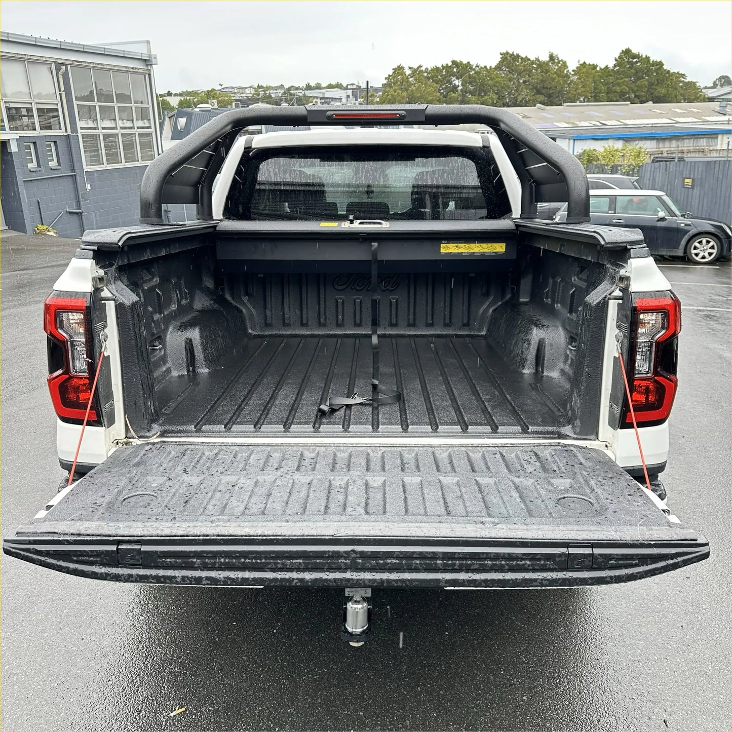 Back view of white ford ranger 2022 with black bed liner featuring roll bar t20 and manual roller shutter free