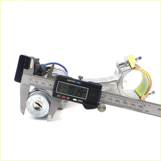 Silver metal car ignition switch with keyhole and wiring measured by caliper on steering column upper bracket for toyota hilux