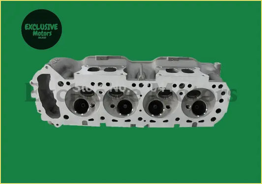 Silver aluminum z24 cylinder head for nissan d21 with four valve chambers and machined surface visible