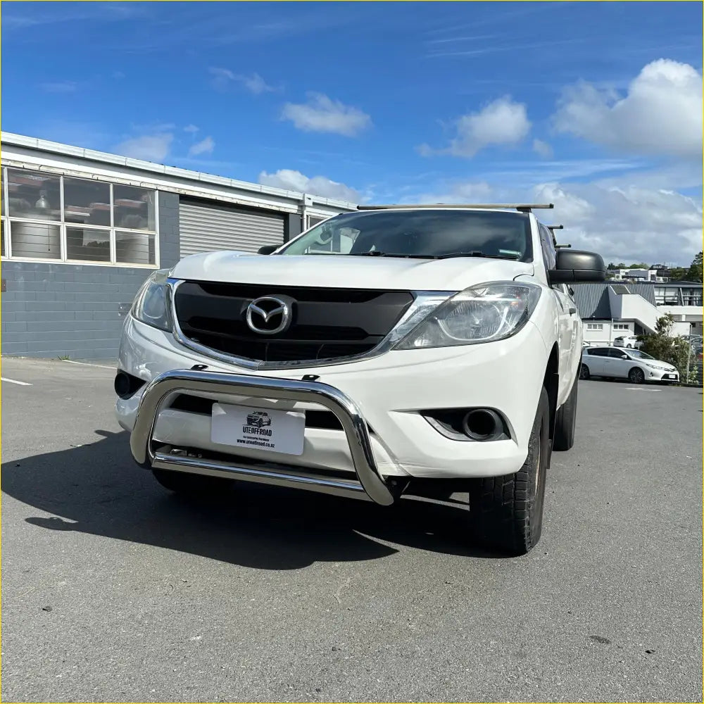 White mazda pickup truck with chrome front bumper and roof rack built for overlanding in nz outdoors adventures