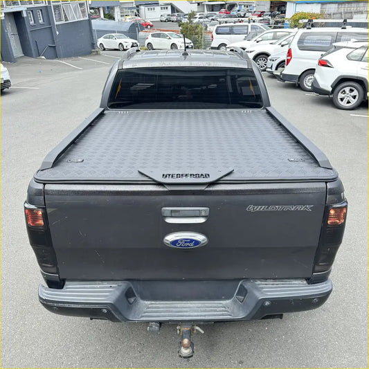 Black diamond plate ute offroad hard lid tonneau cover on ford wildtrak pickup seen from the back side
