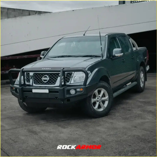 Black nissan navara pickup with rockarmor steel front bumper guard and silver alloy wheels in bullbar review nz 2026
