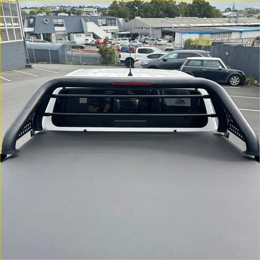 Black metal truck bed rack with perforated side bars and top horizontal bar shown from the back for 4x4 recovery gear