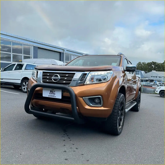 Bronze nissan navara np300 pickup truck with black front bumper guard and rugged off-road tires for nz 2026 build guide