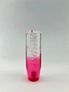 A 15cm bubble gear knob made of translucent glass with vibrant pink liquid and floating red bubbles inside