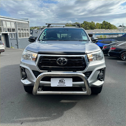 Silver toyota hilux with 304 stainless steel medium size nudge bar chrome bull bar and roof rack visible front side