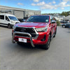 Red toyota hilux with 304 stainless steel chrome nudge bar and black alloy wheels for 2021 to 2025 models