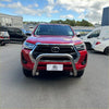 Red Toyota Hilux 2021-2025 with chrome 304 stainless steel nudge bar and black grille front view