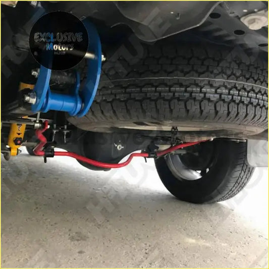 Blue suspension control arm with metallic bolts and yellow shock absorber in 4wd stabilizer sway bar kit for nissan navara np300