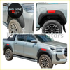 Black plastic 6 inch fender flares with red accents installed on a silver toyota hilux pickup truck