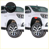 White toyota hilux pickup with 6 inch black fender flares and silver alloy wheels for mudguard protection