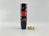Black glossy gear knob with red akatsuki cloud patterns designed as an anime-inspired car accessory