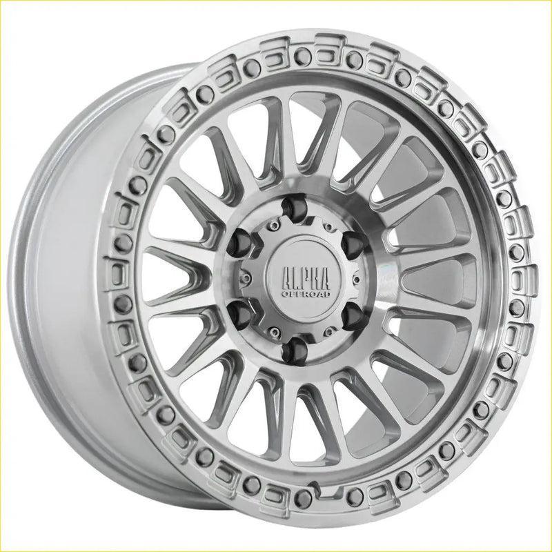 Silver alpha combat overland off-road wheel with machined finish and intricate spoke design 17x9 6x139.7 offset 0
