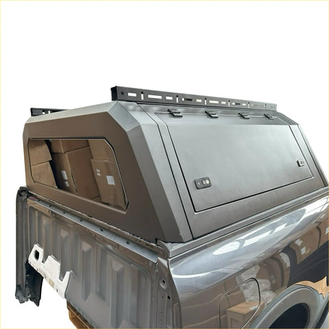 Gray metallic aluminium canopy carport cover with sleek angular design and roof rack for ford ranger 2022+ backside view