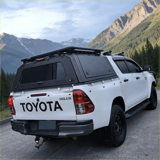 Rear view of white toyota hilux with black aluminium canopy and rear view glass 2015-2025 model