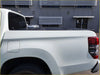 Black aluminium tri fold hardlid tonneau cover fitted over the back bed of a white triton 2015 plus pickup truck
