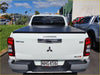 White mitsubishi triton glx-r pickup with black aluminium tri fold hardlid tonneau cover back view