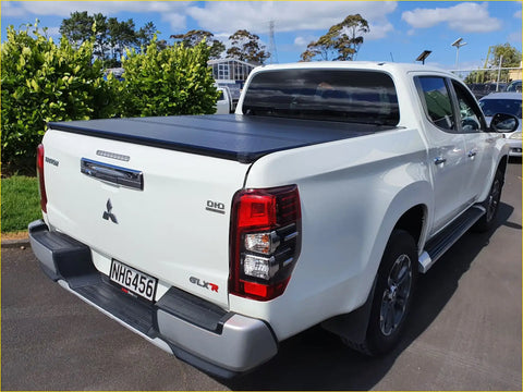 White mitsubishi triton glx-r pickup with black aluminium tri fold hardlid tonneau cover rear view 2015+