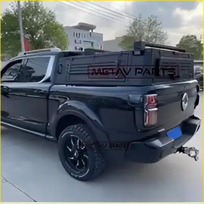 Black matte aluminium ute canopy with rugged off-road tires and roof rack shown from the back on gwm cannon truck