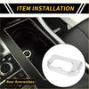 Silver metallic trim cover for the rear armrest box cup holder in a toyota tundra 2022-2024 shown from the back side