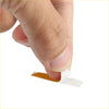 A thin white adhesive strip with brown backing peeled off for silver tone auto mirror switch knob cover on 4wd ute