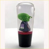 A green three armed alien figurine in a dark blue jacket inside a clear glass container ball z piccolo kid gear knob clear