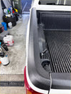 Black textured rubber bedside rail covers with integrated cup holder on white ford ranger px1/2/3 truck bed