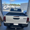 White toyota hilux pickup with black textured bedside rail covers 3 piece set 2015-2020 shown from the back side