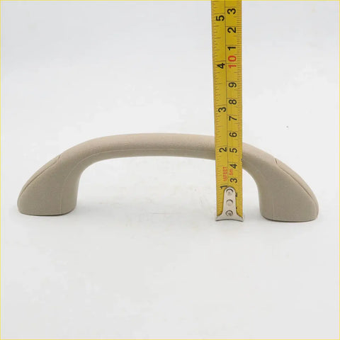 Beige plastic roof grab handle for toyota hilux sr5 2004-2013 with a curved design and smooth surface